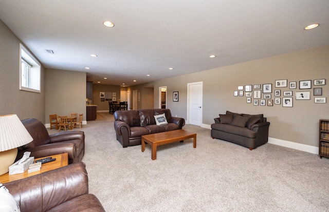 living area featuring carpet floors, visible vents, baseboards, and recessed lighting