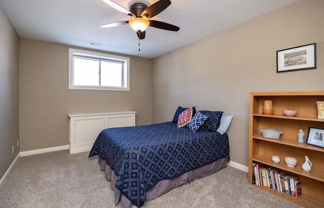 carpeted bedroom with visible vents, baseboards, and ceiling fan