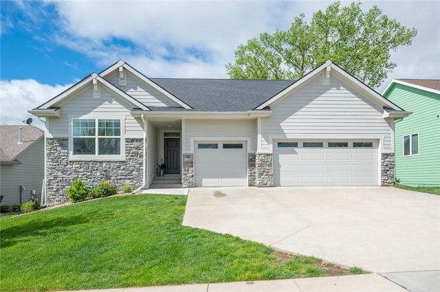 craftsman-style home featuring a garage, driveway, a front lawn, and stone siding