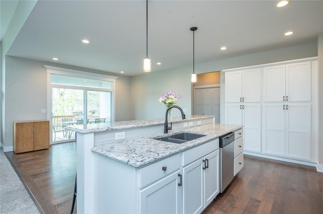 kitchen with dark wood-style floors, a center island with sink, a sink, white cabinets, and dishwasher