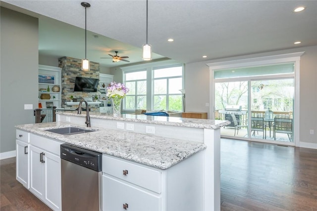 kitchen with open floor plan, plenty of natural light, dishwasher, and a sink