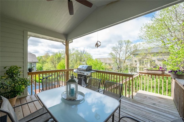 deck with ceiling fan, outdoor dining area, and grilling area