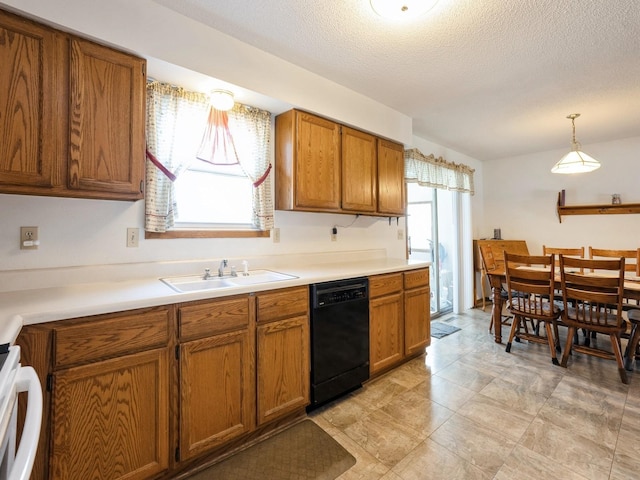 kitchen with black dishwasher, brown cabinets, light countertops, stove, and a sink