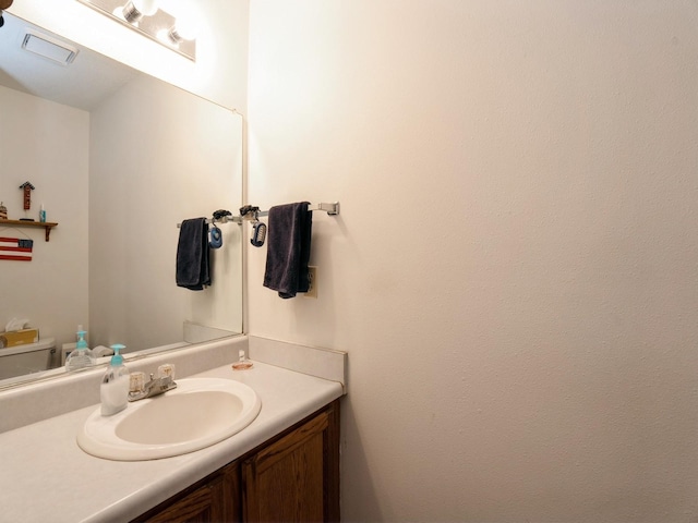 half bath featuring visible vents and vanity