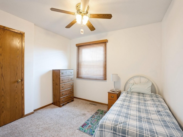 bedroom featuring a ceiling fan, light colored carpet, and baseboards