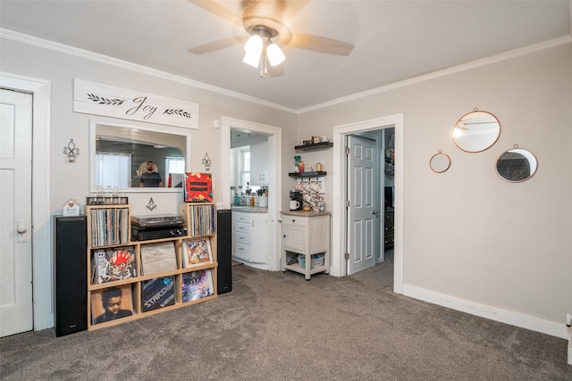 rec room featuring baseboards, ceiling fan, ornamental molding, and carpet flooring