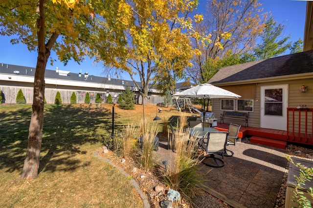 view of yard featuring a patio area, outdoor dining area, and a wooden deck