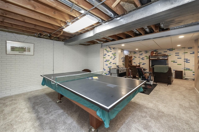 playroom featuring carpet floors and brick wall