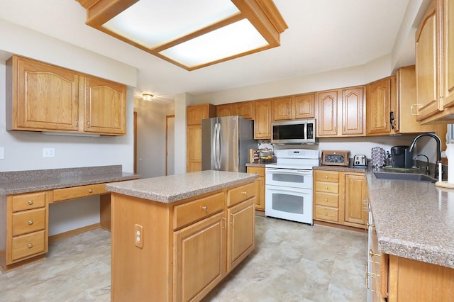 kitchen featuring a kitchen island, light floors, built in desk, a sink, and stainless steel appliances
