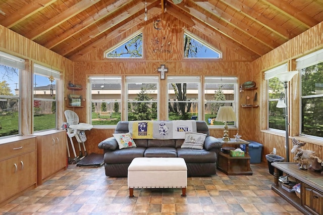 sunroom featuring high vaulted ceiling, wooden walls, wooden ceiling, and beamed ceiling