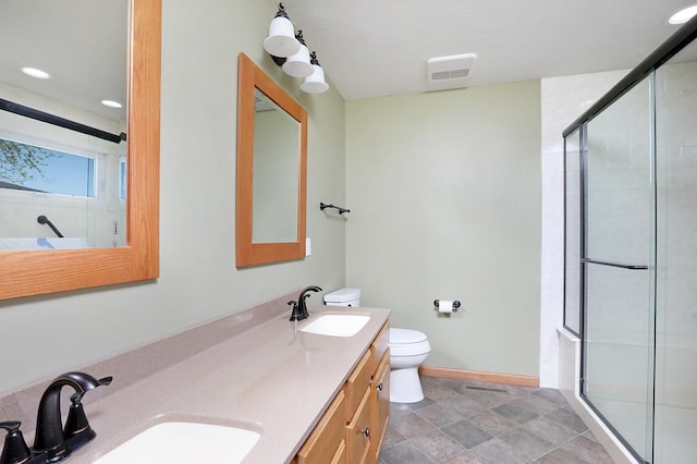 bathroom with baseboards, a sink, toilet, and a shower stall