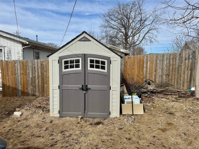 view of shed featuring fence