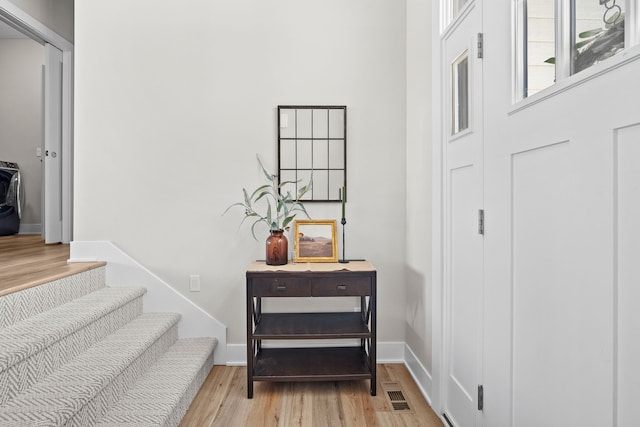 interior space featuring wood finished floors, visible vents, and baseboards