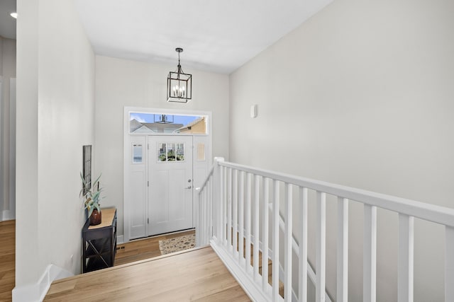 foyer with a chandelier and wood finished floors