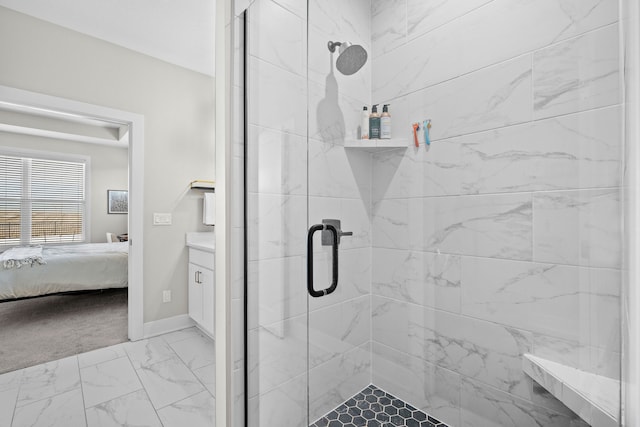 ensuite bathroom featuring marble finish floor, baseboards, a stall shower, and ensuite bathroom