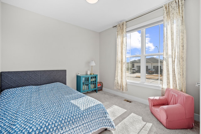 bedroom featuring baseboards, visible vents, and carpet flooring