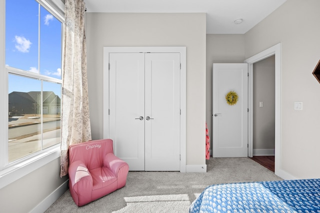 bedroom featuring a closet, carpet, and baseboards