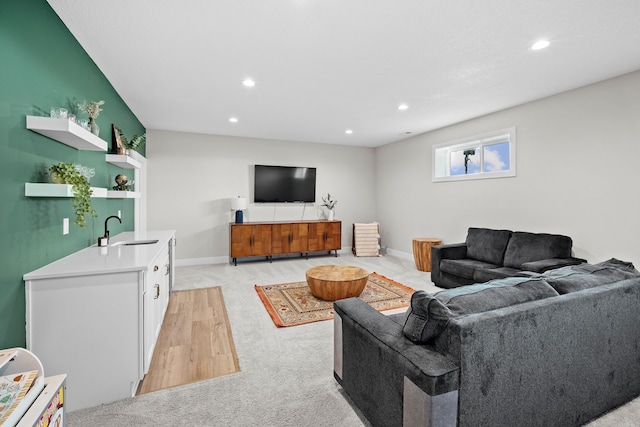 living room featuring baseboards, light carpet, and recessed lighting