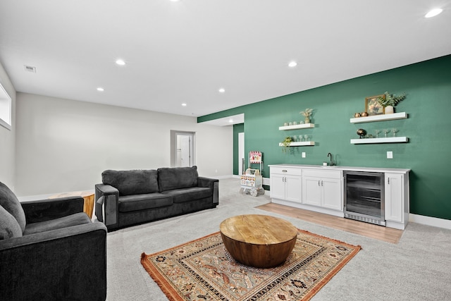 living area featuring recessed lighting, beverage cooler, indoor wet bar, and baseboards