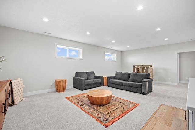 living room featuring carpet, visible vents, baseboards, and recessed lighting