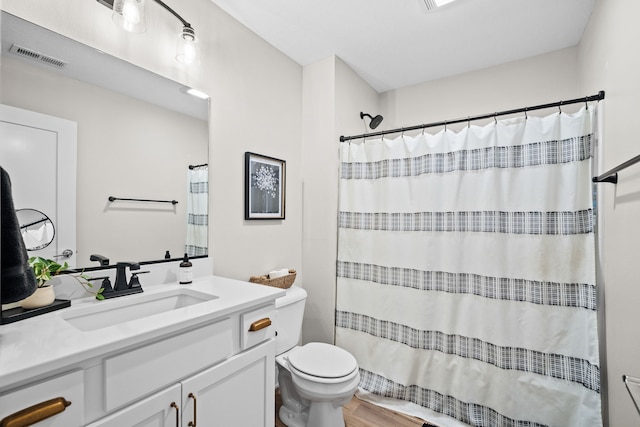 bathroom featuring a shower with curtain, visible vents, vanity, and toilet