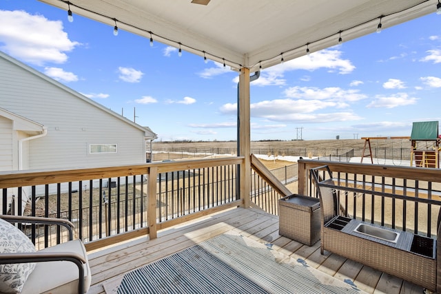 deck featuring fence and a rural view