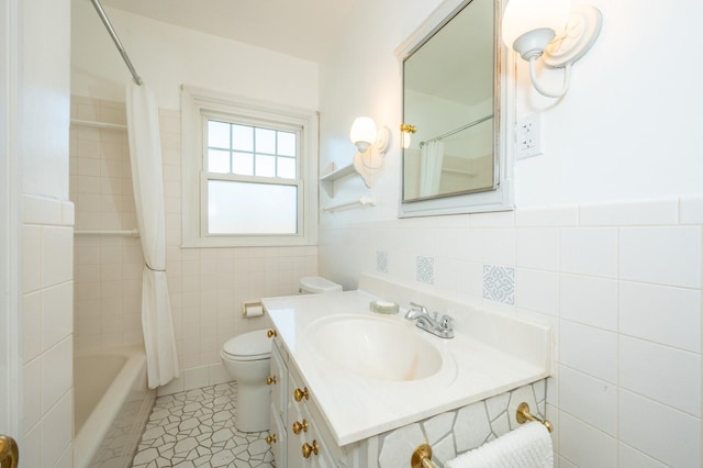 full bathroom with toilet, shower / tub combo, vanity, tile walls, and tile patterned floors