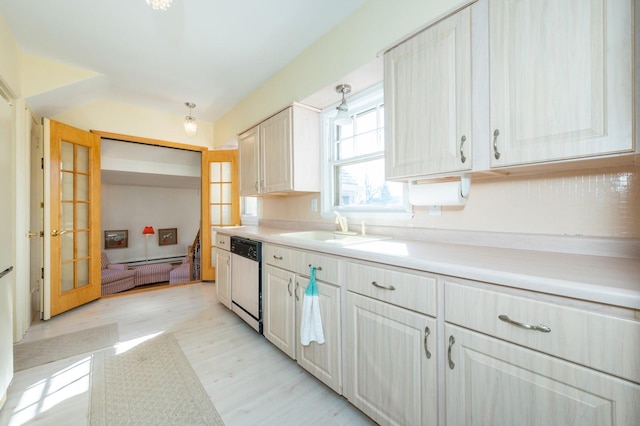 kitchen featuring light wood-style flooring, a sink, light countertops, french doors, and dishwasher