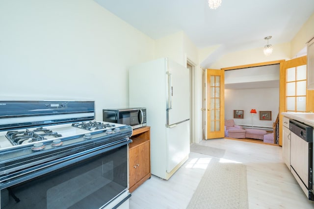 kitchen featuring french doors, appliances with stainless steel finishes, light countertops, and light wood-style flooring