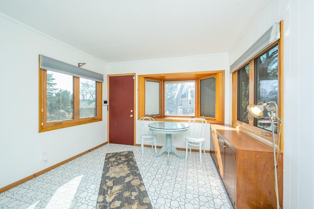 dining room with baseboards and ornamental molding