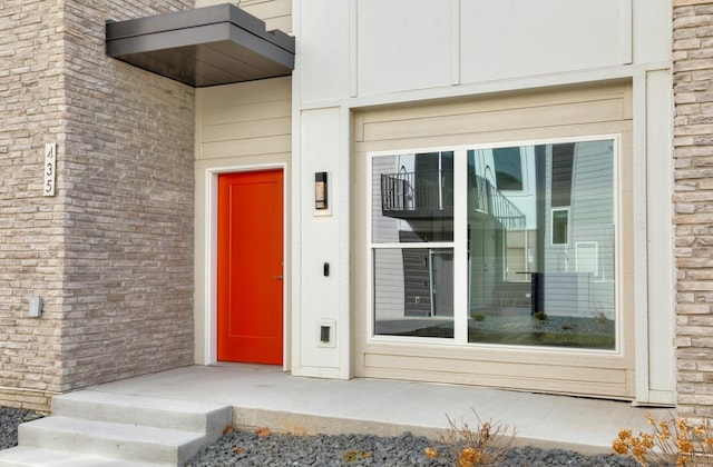 doorway to property with brick siding