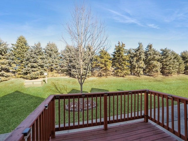 wooden terrace featuring a yard