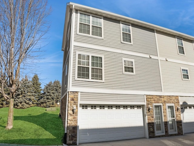 view of front of house featuring a garage, stone siding, and concrete driveway