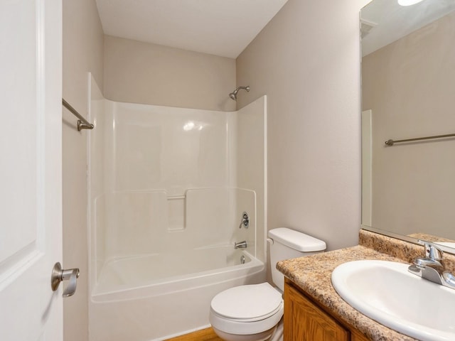 bathroom with toilet, shower / bathing tub combination, and vanity