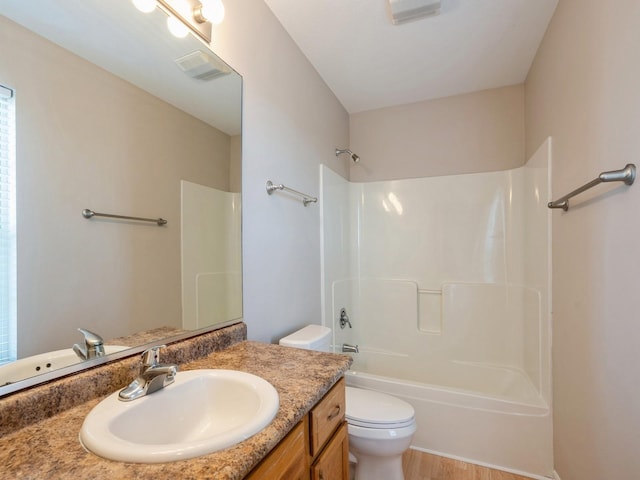 bathroom with visible vents, shower / bathing tub combination, vanity, and toilet