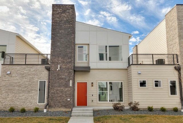 back of property featuring a balcony