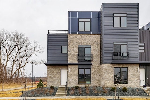 exterior space with brick siding and a balcony