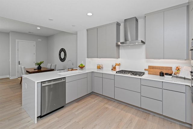 1160 Murphy St, Des Moines, IA 50309 - kitchen with gray cabinets, appliances with stainless steel finishes, wall chimney range hood, a peninsula, and modern cabinets