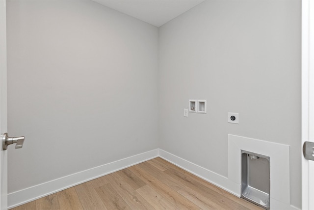 1160 Murphy St, Des Moines, IA 50309 - washroom featuring washer hookup, hookup for an electric dryer, light wood-style flooring, and baseboards
