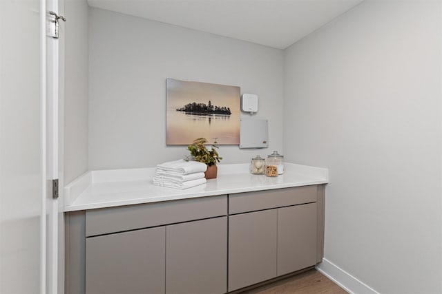 1160 Murphy St, Des Moines, IA 50309 - bathroom with wood finished floors, baseboards, and vanity