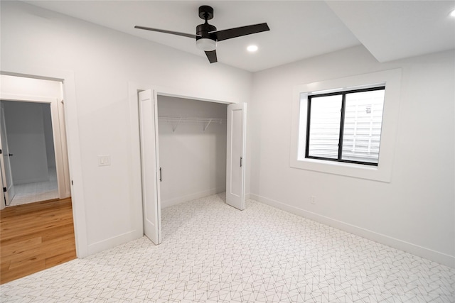 unfurnished bedroom featuring recessed lighting, a closet, light colored carpet, and baseboards