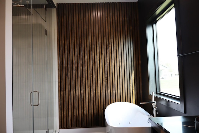 bathroom featuring a stall shower, vanity, and a wealth of natural light