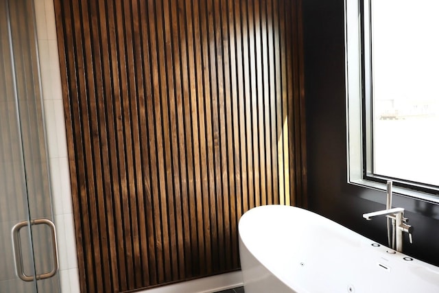 bathroom featuring a soaking tub, a sink, and a shower stall