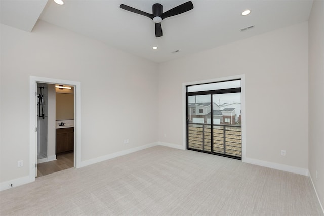 spare room with light colored carpet and baseboards