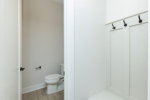 1166 Murphy St, Des Moines, IA 50309 - bathroom featuring toilet, wood finished floors, and baseboards