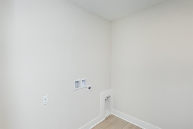 clothes washing area featuring laundry area, baseboards, light wood-style flooring, washer hookup, and electric dryer hookup