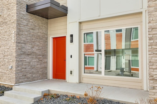 doorway to property featuring brick siding