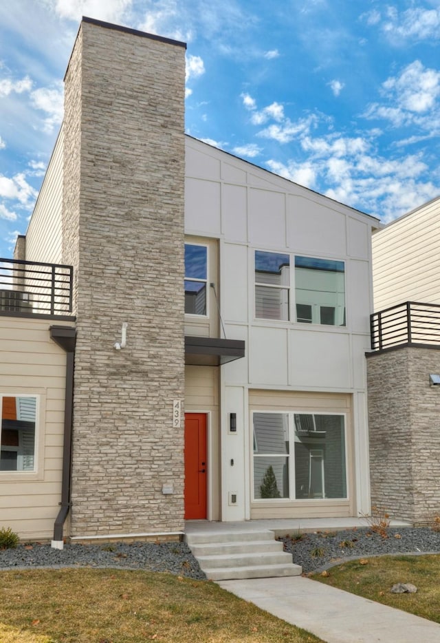 exterior space with a balcony and stucco siding