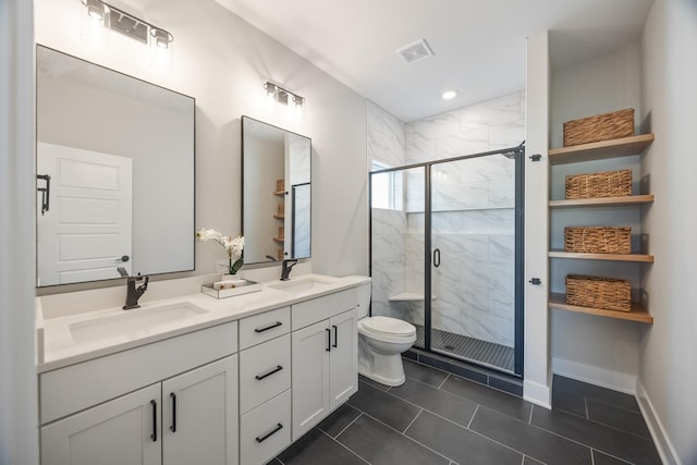 full bath with toilet, double vanity, a sink, and visible vents