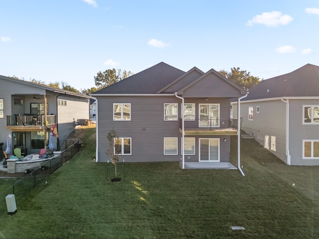 rear view of house featuring a deck, central AC, a lawn, and a patio area